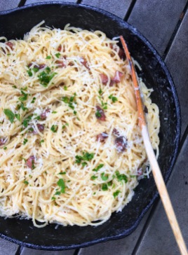 Spaghetti carbonara pasta with guanciale in cast iron skillet